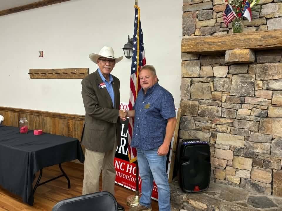 Mike Perdue greeting a community leader at a local gathering.