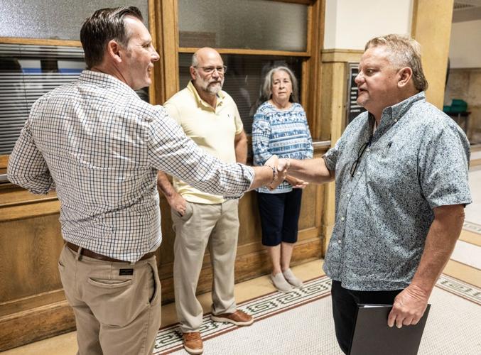 Mike Perdue shaking hands with a Guilford County resident after a public meeting.